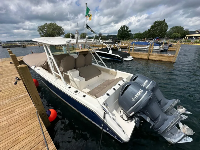 Slide: The Image of 2015 Pursuit ST 310 Sport boat docked with twin Yamaha engines. - 3