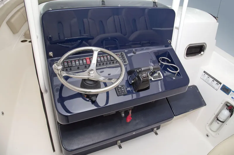 Slide: The Image of Manufacturer Provided Image: 2015 Pursuit ST 310 Sport boat helm with steering wheel and control panel. - 30