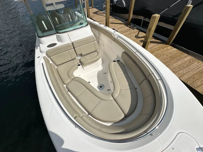 Slide: The Image of 2015 Pursuit ST 310 Sport boat with spacious seating, docked by wooden pier. - 7