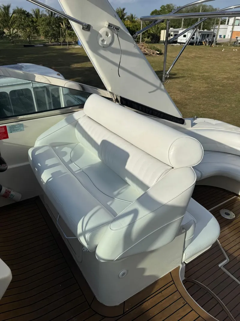 Slide: The Image of 2000 Cruisers Yachts 3870 Express white leather seating on deck, showcasing luxury and comfort. - 18