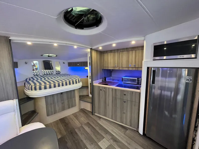 Slide: The Image of Luxurious interior of 2000 Cruisers Yachts 3870 Express with modern kitchen and cozy sleeping area. - 21