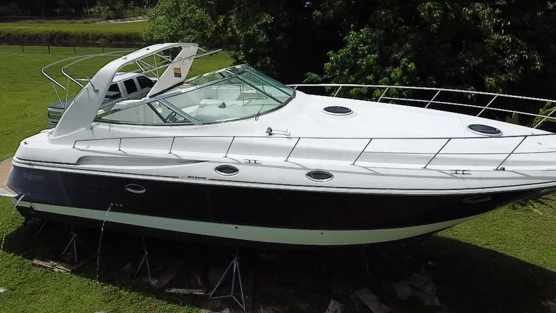 Slide: The Image of 2000 Cruisers Yachts 3870 Express on stands, surrounded by greenery. - 5