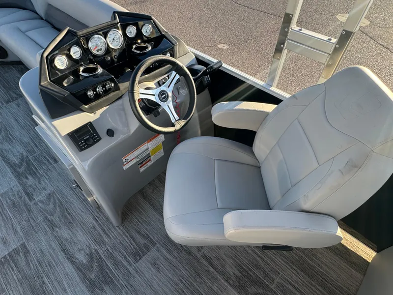 Slide: The Image of 2024 Landau Island Breeze 252 boat helm with steering wheel and gauges. - 6
