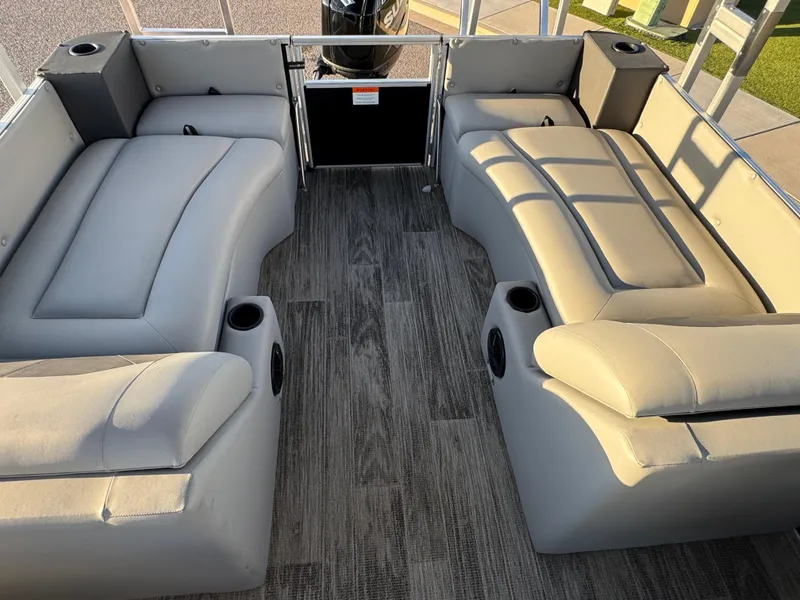 Slide: The Image of 2024 Landau Island Breeze 252 pontoon boat interior with gray seating and wood-style flooring. - 8