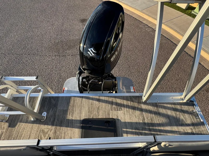 Slide: The Image of 2024 Landau Island Breeze 252 pontoon boat with Suzuki outboard motor, viewed from above. - 9