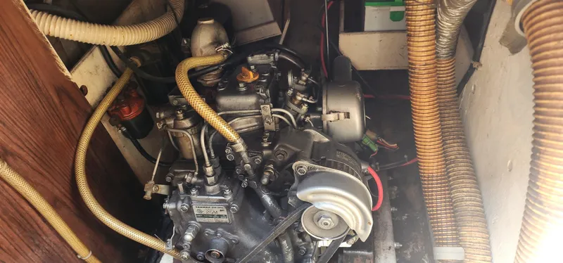 Slide: The Image of Engine compartment of a 1984 Caliber 28 sailboat, featuring a Yanmar 2GM diesel engine. - 14