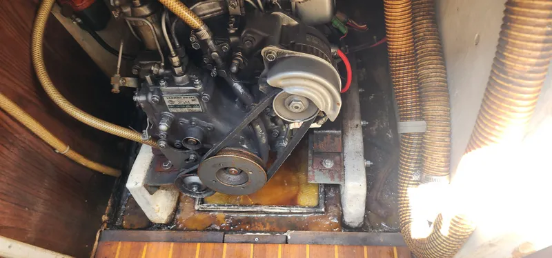 Slide: The Image of Engine compartment of a 1984 Caliber 28 sailboat, showing mechanical components and hoses. - 15