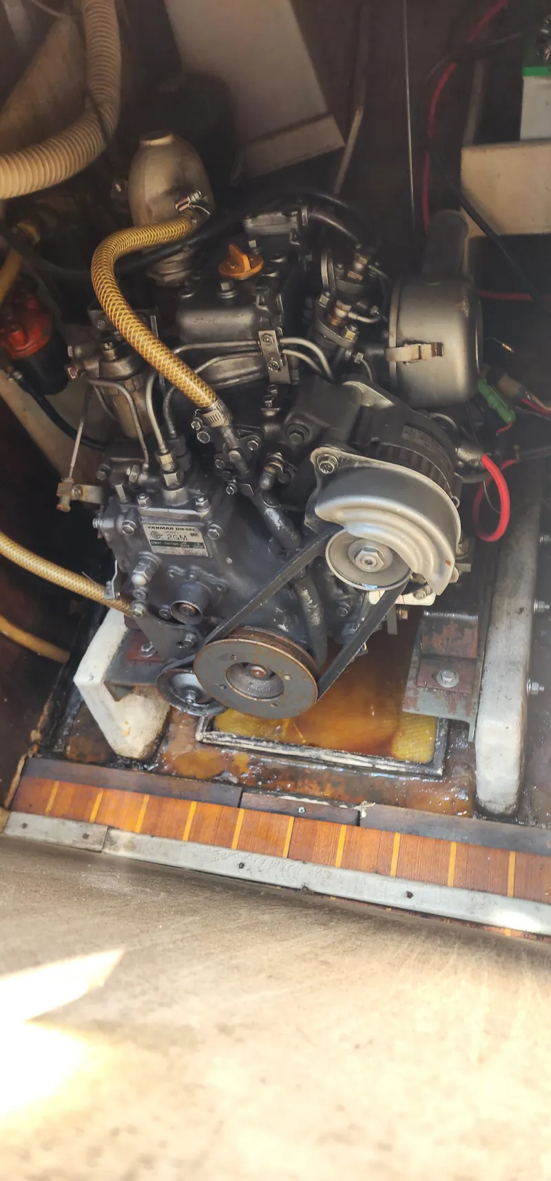 Slide: The Image of 1984 Caliber 28 engine compartment with visible mechanical components and belts. - 16