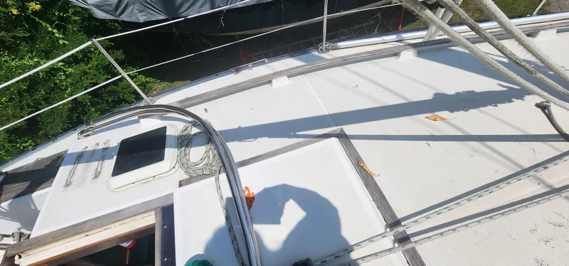 Slide: The Image of Deck of 1984 Caliber 28 sailboat with ropes and hatch, under sunlight. - 18