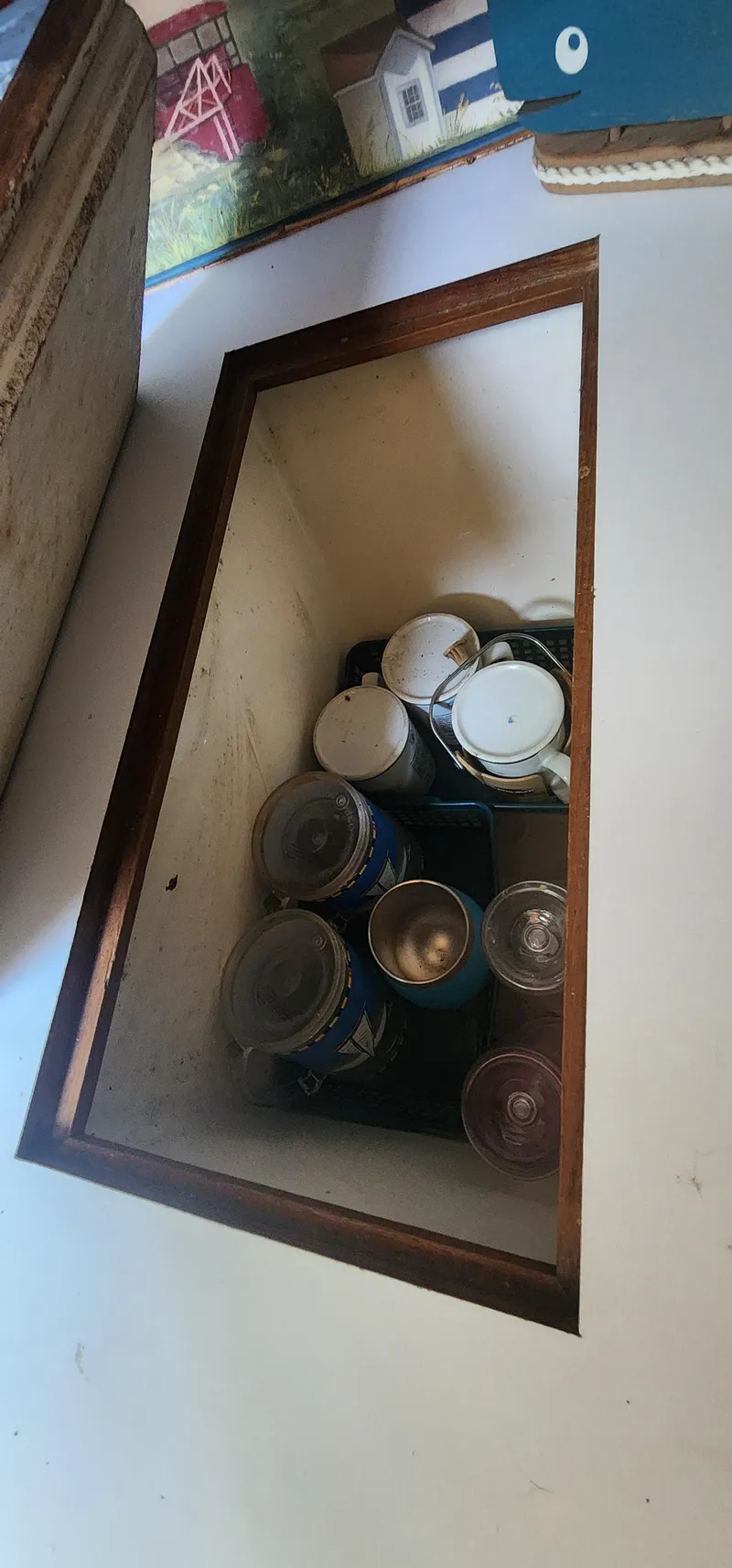 Slide: The Image of Hidden storage compartment with canned goods on a Caliber 28, 1984 model. - 4