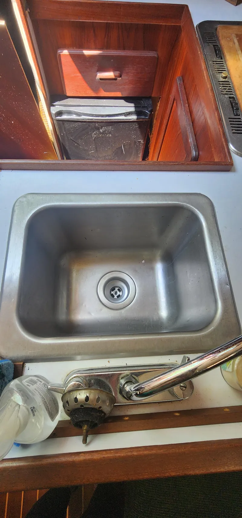Slide: The Image of Stainless steel sink in 1984 Caliber 28 boat kitchen with wooden cabinetry. - 5