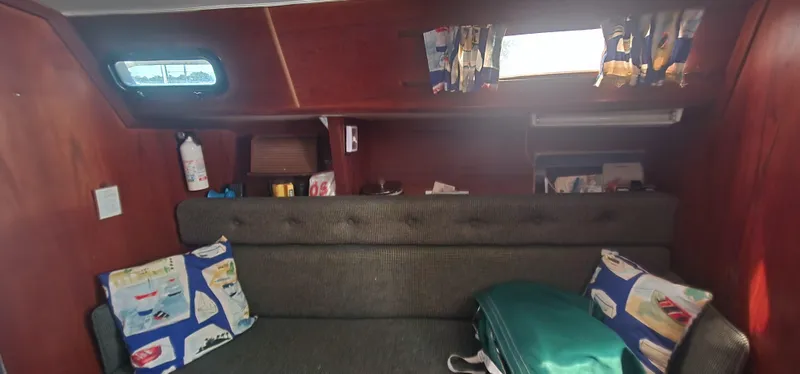 Slide: The Image of Interior of a 1984 Caliber 28 sailboat with cozy seating and nautical-themed decor. - 9