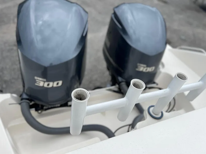Slide: The Image of Twin Yamaha 300 outboard engines on a 2016 Pursuit 325 DC boat, with rod holders. - 11