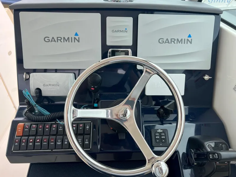 Slide: The Image of Helm of 2016 Pursuit 325 DC with Garmin navigation displays and controls. - 16