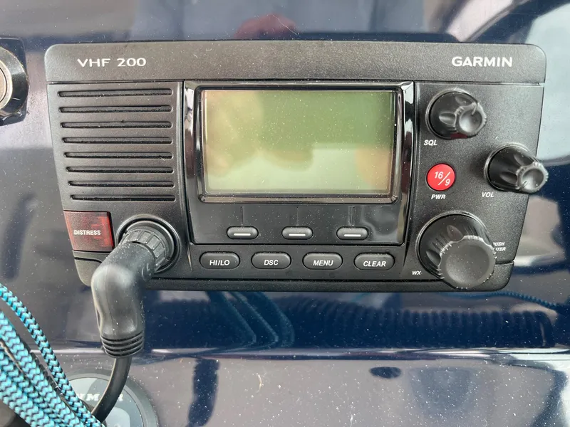 Slide: The Image of Garmin VHF 200 radio on 2016 Pursuit 325 DC boat dashboard. - 18