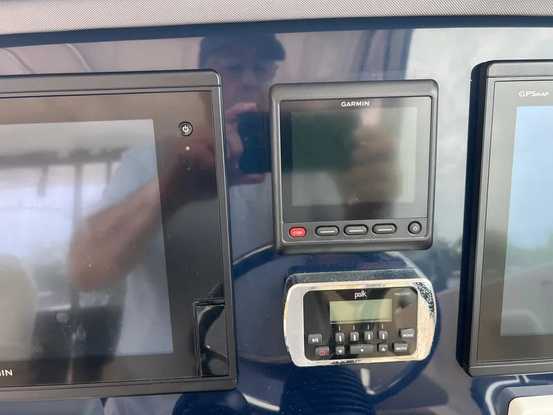 Slide: The Image of Control panel of a 2016 Pursuit 325 DC boat with Garmin and Polk displays. - 20