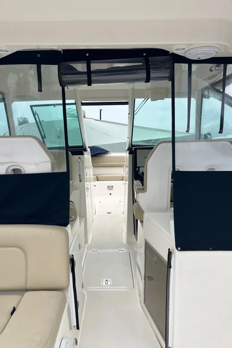 Slide: The Image of Interior view of 2016 Pursuit 325 DC boat, featuring seating and helm area. - 22