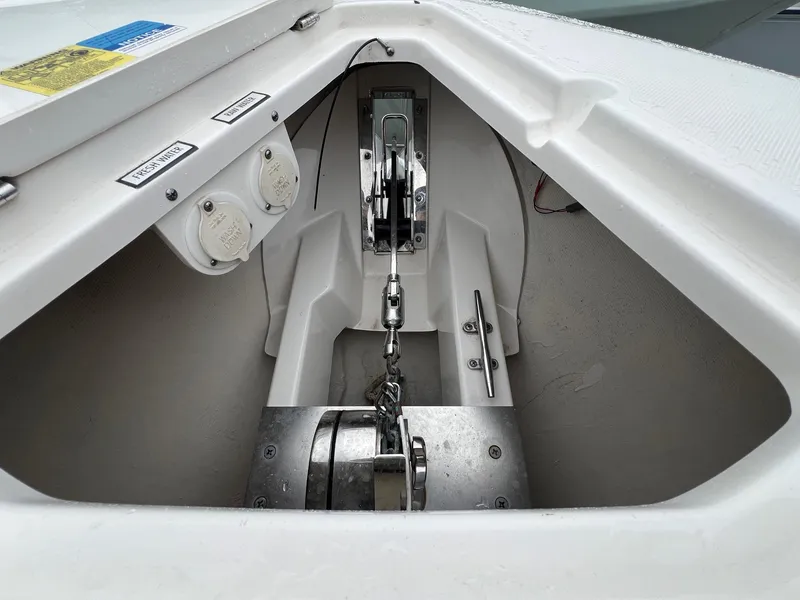 Slide: The Image of Anchor compartment of 2016 Pursuit 325 DC boat with chain and winch system. - 28