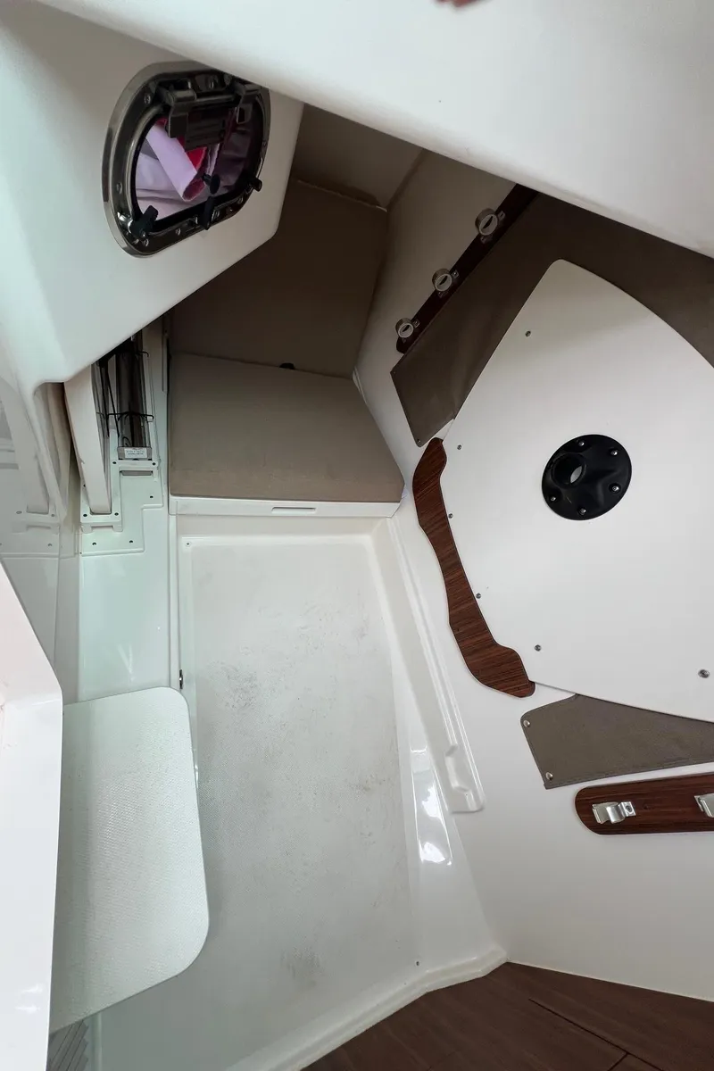 Slide: The Image of 2016 Pursuit 325 DC boat interior with seating and storage area. - 31
