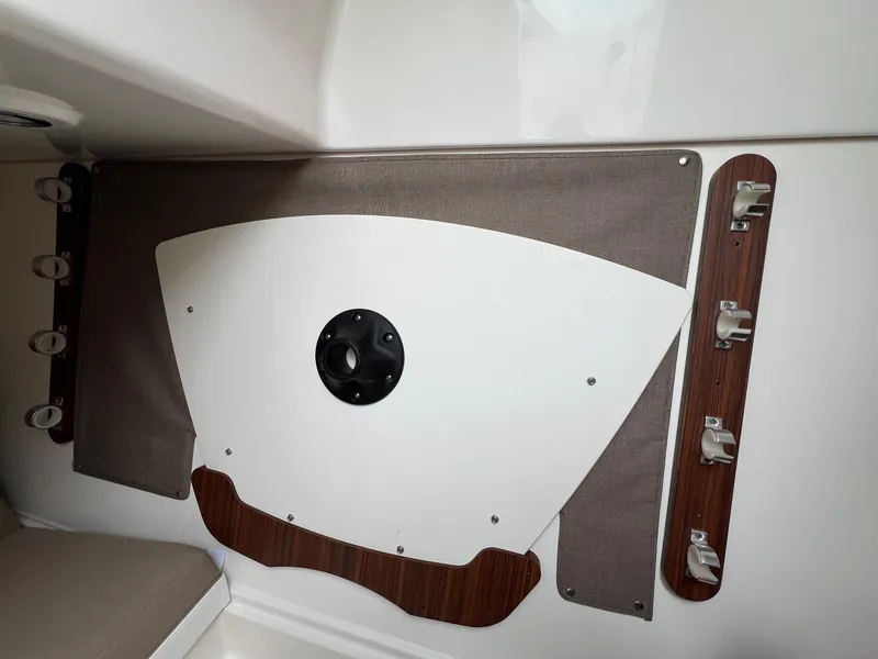 Slide: The Image of Interior detail of a 2016 Pursuit 325 DC boat, featuring storage and mounting fixtures. - 32