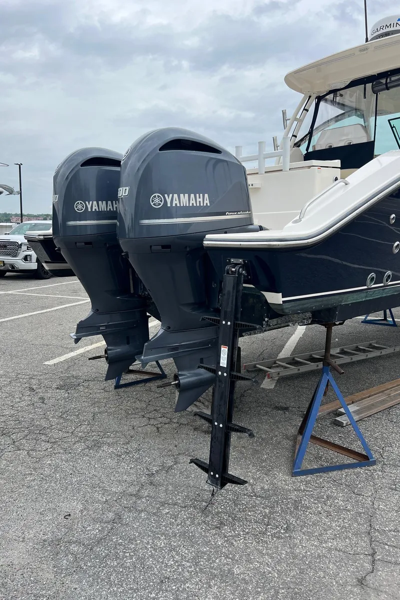 Slide: The Image of 2016 Pursuit 325 DC boat with dual Yamaha outboard engines on a trailer. - 5
