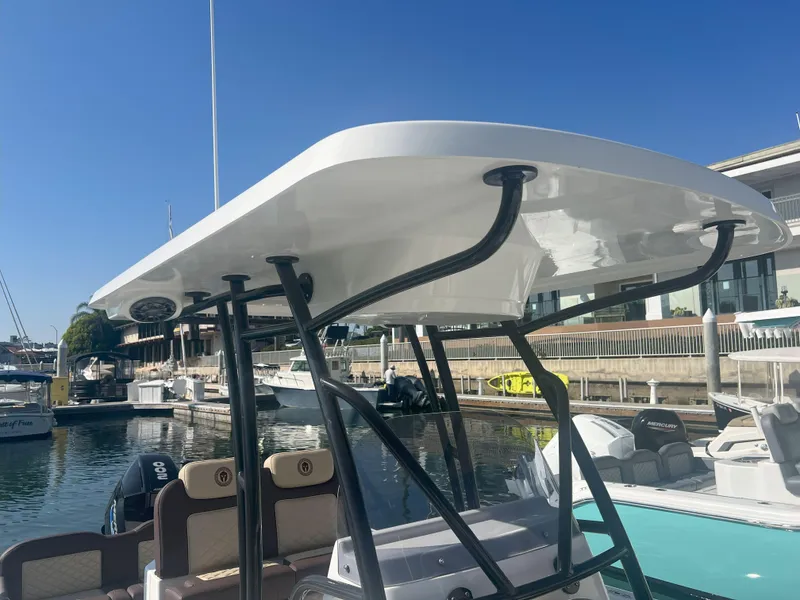 Slide: The Image of Modern Reflex Gladiator 2400 boat at marina, showcasing sleek design and sturdy canopy, 2026 model. - 13