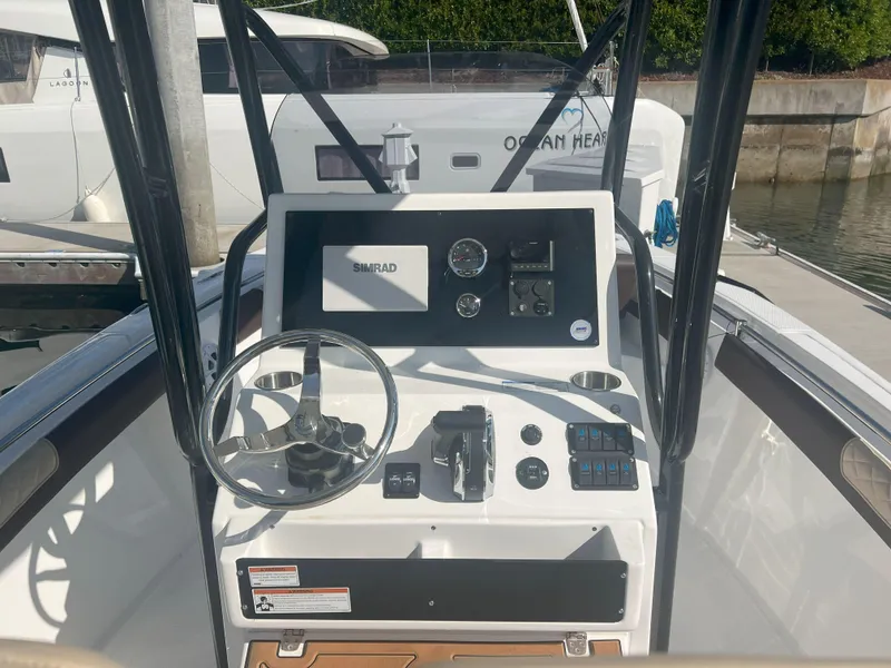 Slide: The Image of Control panel of Reflex Gladiator 2400 boat, featuring steering wheel and navigation instruments. - 15