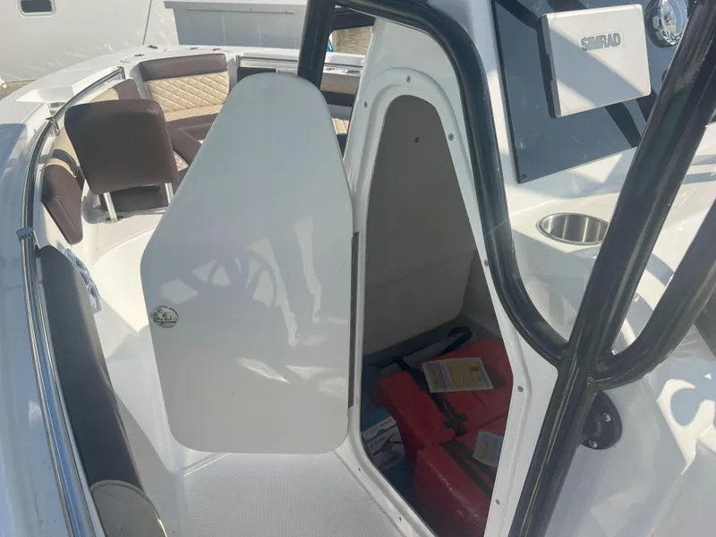 Slide: The Image of 2026 Reflex Gladiator 2400 boat interior with open cabin door and visible life jackets. - 18