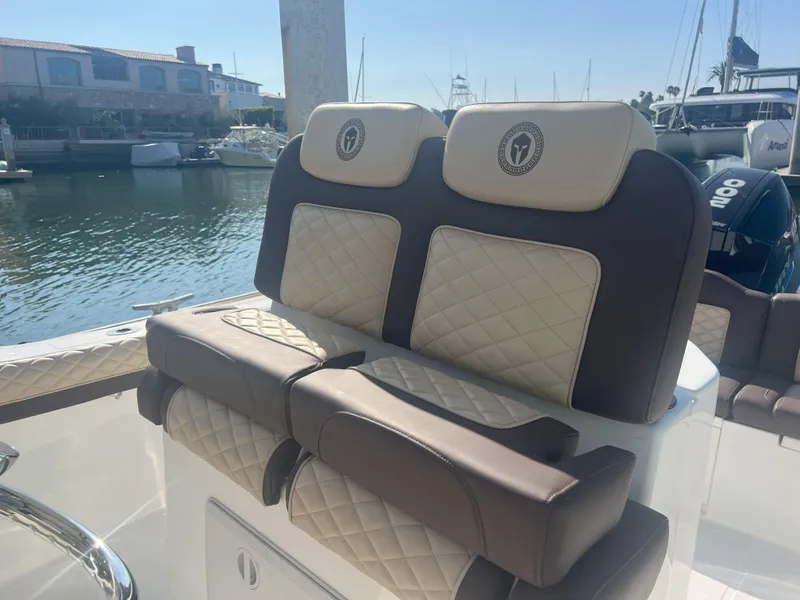 Slide: The Image of Luxurious seating on a 2026 Reflex Gladiator 2400 boat, featuring diamond-stitched upholstery. - 22