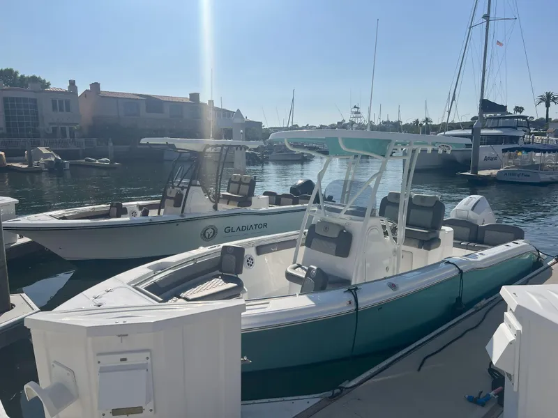 Slide: The Image of Boats docked at marina, featuring 2026 Reflex Gladiator 2400 model. - 29