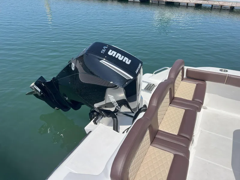 Slide: The Image of Reflex Gladiator 2400 boat, 2026 model, with Mercury outboard motor and cushioned seating. - 49