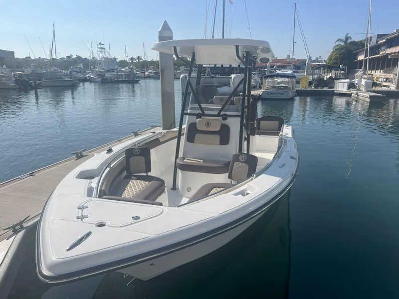 Slide: The Image of 2026 Reflex Gladiator 2400 boat docked in a marina, surrounded by other vessels. - 6