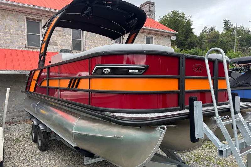Slide: The Image of 2026 Bentley Pontoons Elite 223 Swingback with Wake Tower, vibrant red and orange design. - 1