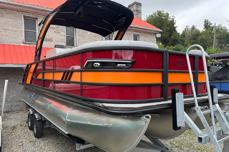 Slide: The Image of 2026 Bentley Pontoons Elite 223 Swingback with Wake Tower, vibrant red and orange design. - 2