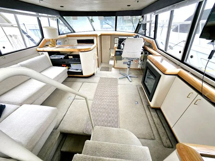 Slide: The Image of Interior of 1990 Bayliner 4387 Motoryacht with helm, seating, and modern amenities. - 10