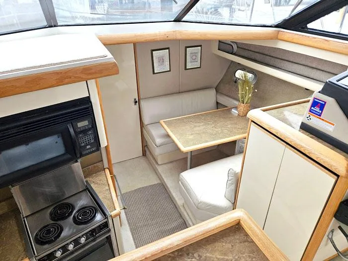 Slide: The Image of Interior of 1990 Bayliner 4387 Motoryacht with kitchen and dining area. - 15