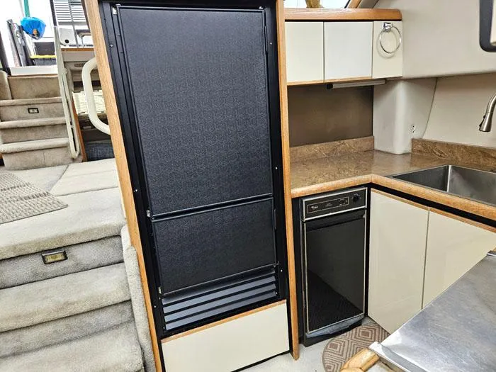 Slide: The Image of Interior of 1990 Bayliner 4387 Motoryacht kitchen with fridge, sink, and cabinetry. - 17