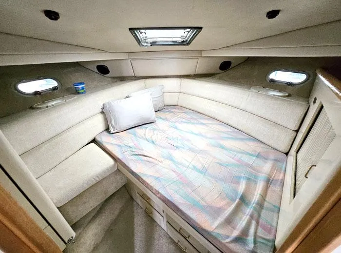 Slide: The Image of Cozy cabin interior of 1990 Bayliner 4387 Motoryacht with bed and portholes. - 19