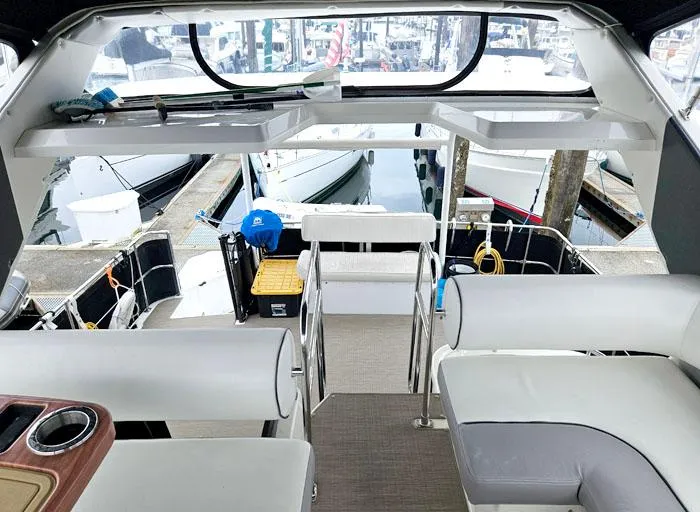 Slide: The Image of 1990 Bayliner 4387 Motoryacht interior with marina view, featuring comfortable seating and modern design. - 7