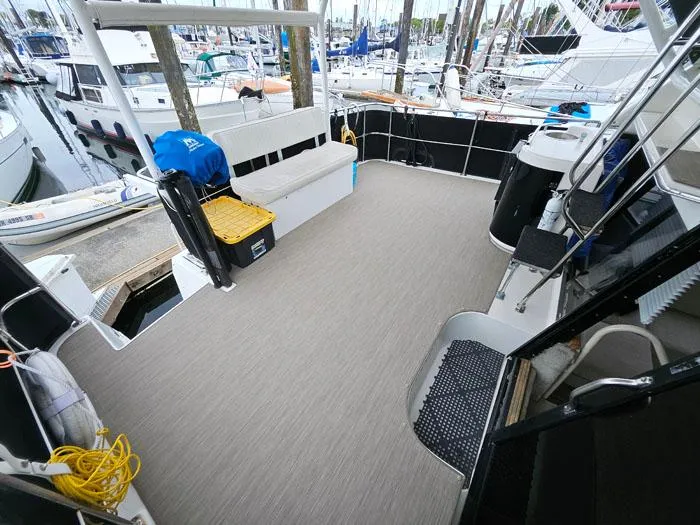 Slide: The Image of 1990 Bayliner 4387 Motoryacht deck with seating, docked at marina. - 8