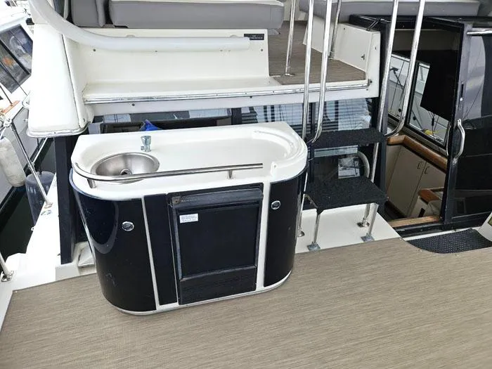 Slide: The Image of 1990 Bayliner 4387 Motoryacht interior with sink and stairs, featuring modern design elements. - 9