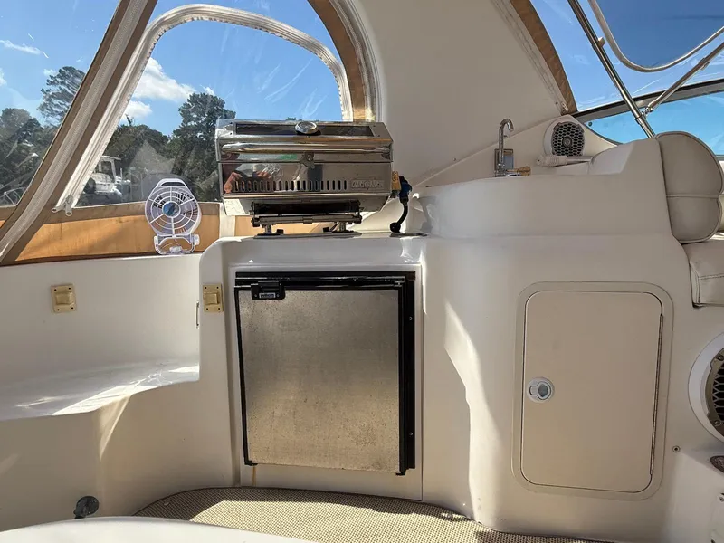 Slide: The Image of 2000 Cruisers Yachts 3375 Express interior with grill, mini fridge, and sink. - 10