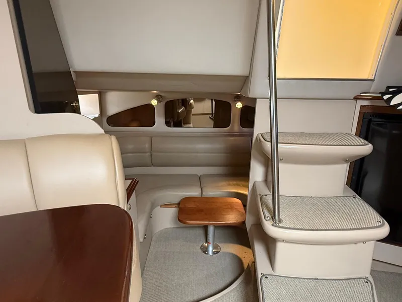 Slide: The Image of Interior of 2000 Cruisers Yachts 3375 Express with beige seating and wooden accents. - 15