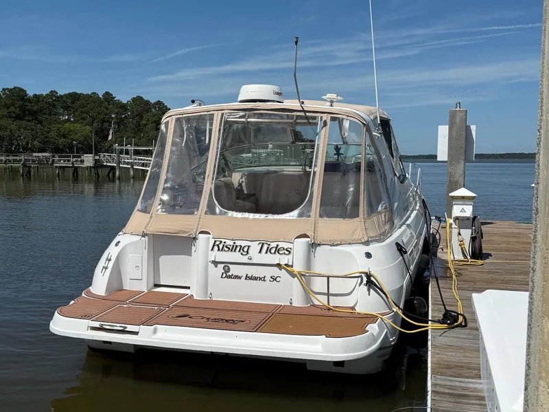 Slide: The Image of 2000 Cruisers Yachts 3375 Express docked at marina, clear skies, calm water. - 2