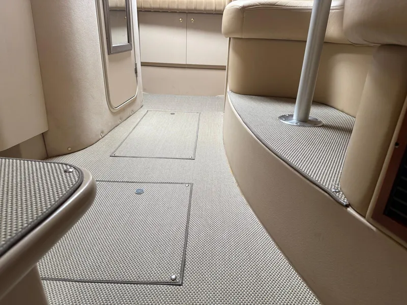 Slide: The Image of Interior of 2000 Cruisers Yachts 3375 Express, featuring beige carpet and seating. - 23