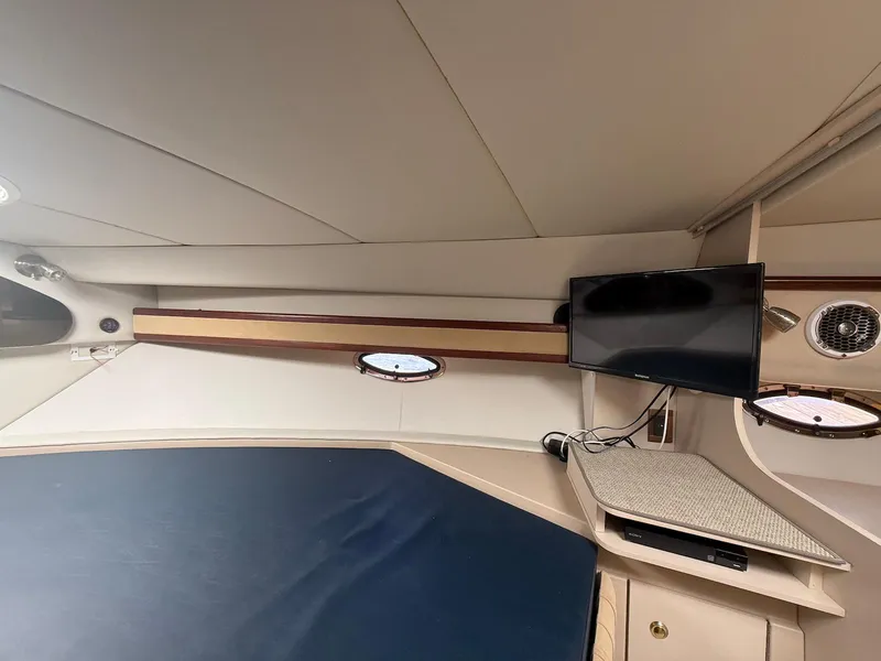 Slide: The Image of Interior of 2000 Cruisers Yachts 3375 Express with TV and porthole. - 27