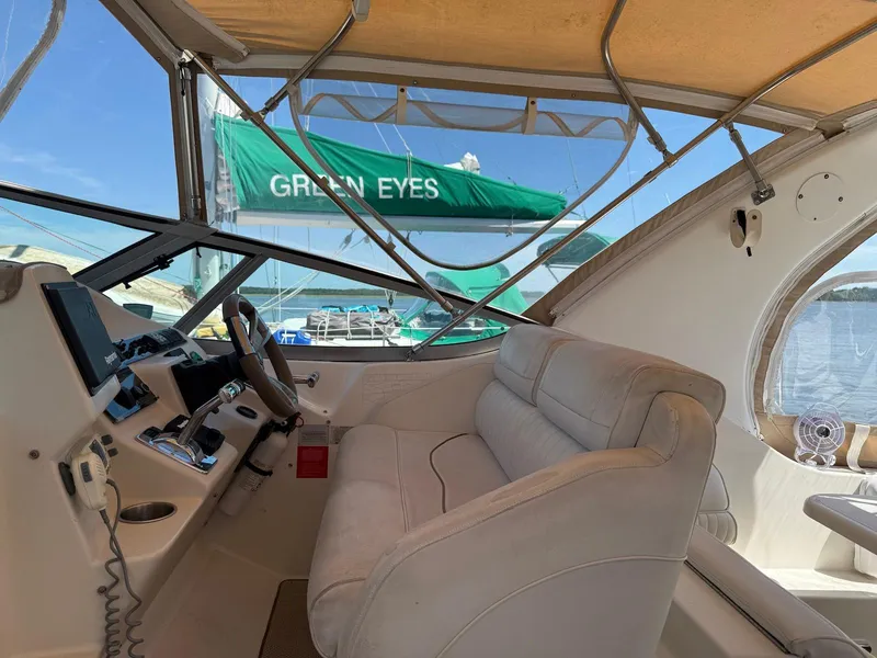 Slide: The Image of Interior view of 2000 Cruisers Yachts 3375 Express with helm and seating. - 4