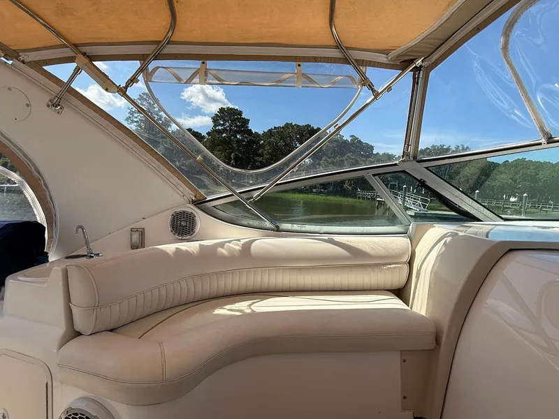 Slide: The Image of Interior of 2000 Cruisers Yachts 3375 Express with cream seating and scenic window view. - 6