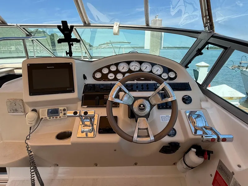 Slide: The Image of Cockpit of 2000 Cruisers Yachts 3375 Express with steering wheel and control panel. - 7