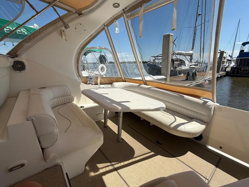 Slide: The Image of Interior of 2000 Cruisers Yachts 3375 Express with seating and table, docked at marina. - 9